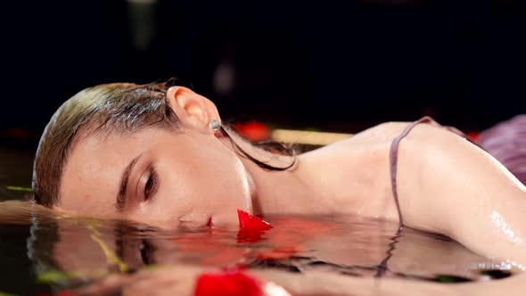 Seductive Young Woman is Lying in Fabulous Lake or Pond in Night Closeup Portrait of Beauty