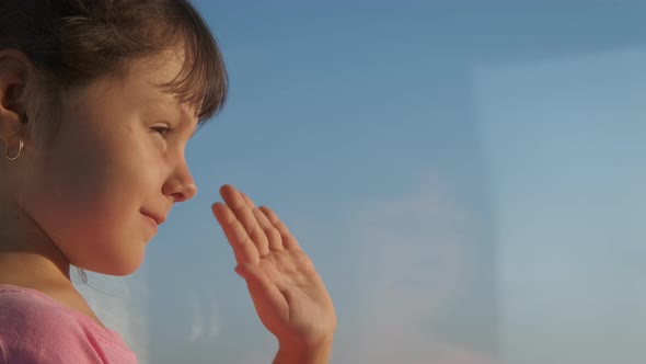 Happy child looks out the window. 