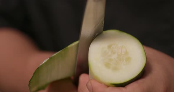 Peeling The Fresh Cucumber With A Chef's Knife For Sushi Roll. - Close Up Shot