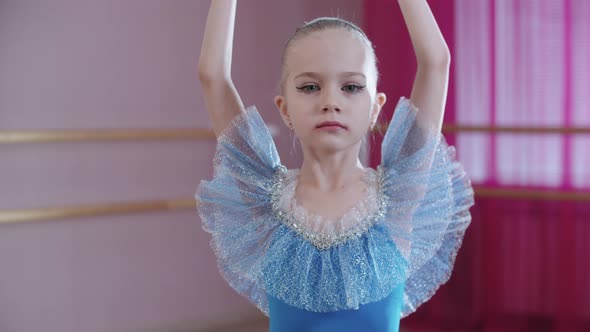 Ballet Training  a Little Girl in Blue Dress Spinning on the Spot