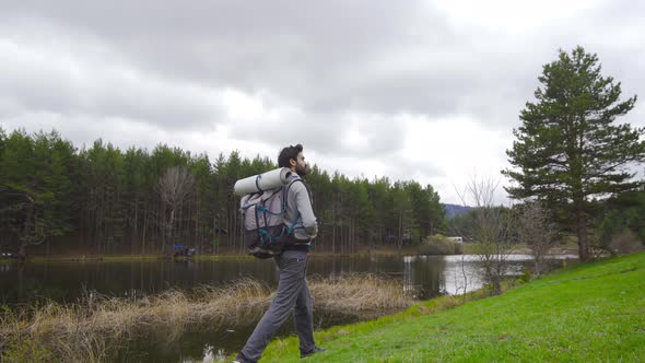 Man walking by lake in nature.