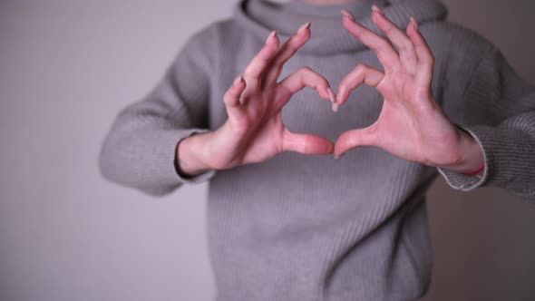 footage of hand gesture heart love