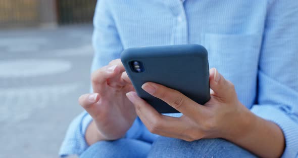 Close up Of Woman Use of Smart Phone in City