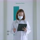Asian female doctor reading patient history report while walking along hospital corridor - VideoHive Item for Sale