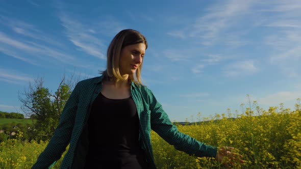 Successful Female Farmer Walks Through His Bloomed Rapeseed Field Bloomed