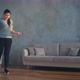 Woman in Sportswear and Shoes Jumps Rope on Laminate in Room - VideoHive Item for Sale