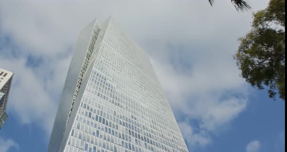 Timelapse of modern glass skyscraper in Tel Aviv, Israel with cloud relfections