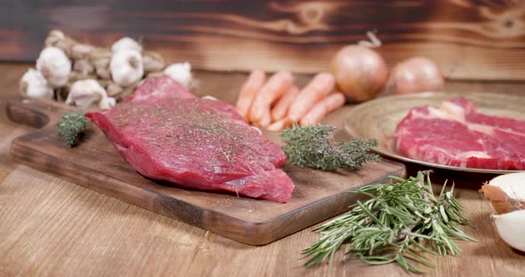 Fresh, Raw, Juicy Beef Steak on a Wooden Vintage Board