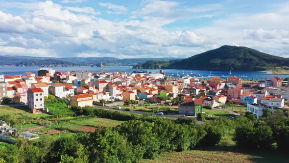 Scenic aerial view of coastal housing village in idyllic natural environment at sunny day