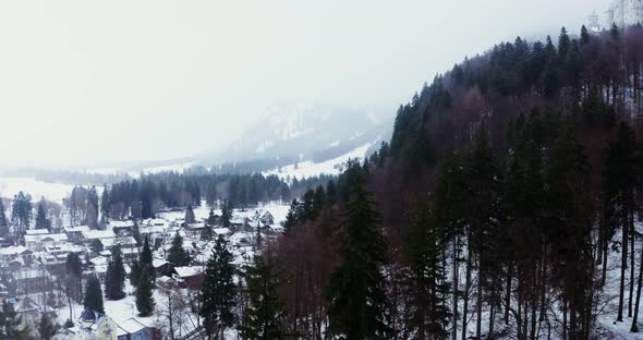 A Small Town with Cottage Development at the Foot of a Hill in Winter