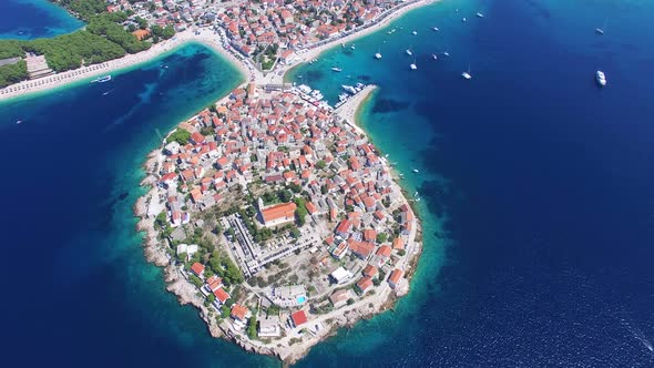 Flying above traditional dalmatian houses on Primosten peninsula, Croatia