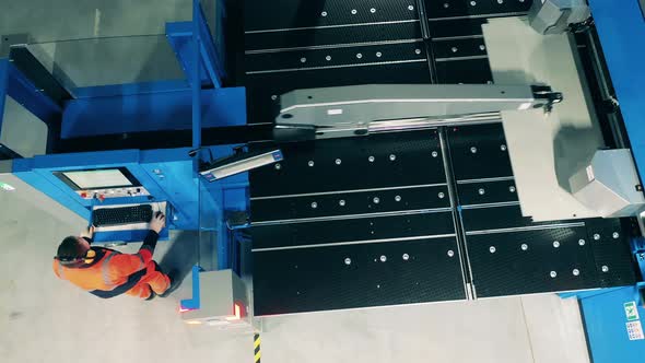 Technician Is Operating a Shearing Machine in a Top View