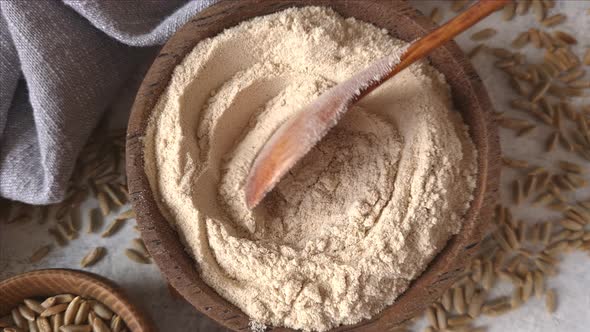 Raw rye flour in a bowl close up