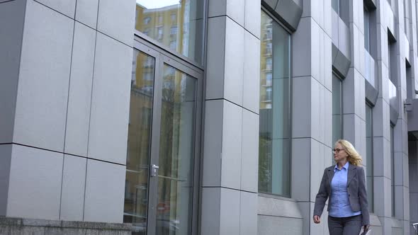 Happy Female Politician Admiring Reflection in Office Building Glass, Career