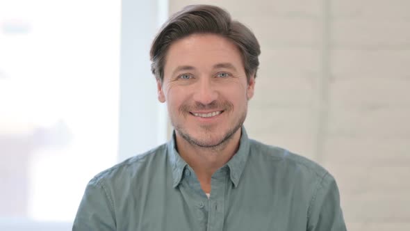 Portrait of Middle Aged Man Smiling at Camera