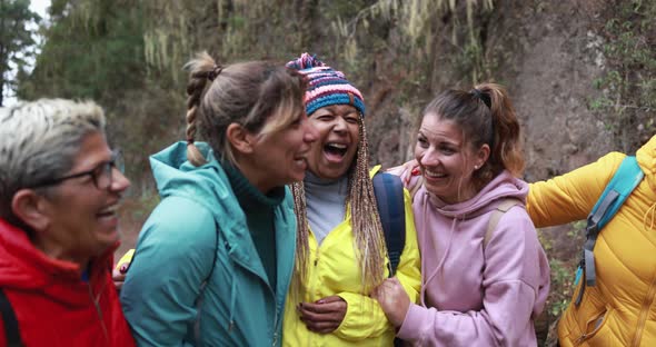 Multiracial women having fun during trekking day into the wood