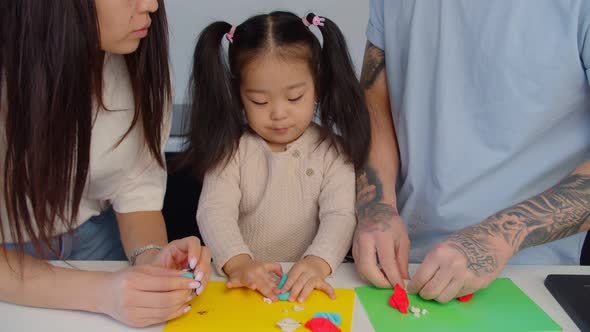 Creative Asian Toddler Girl Making Toy From Play Dough