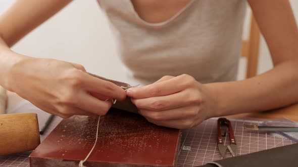 Woman making leather craft at home