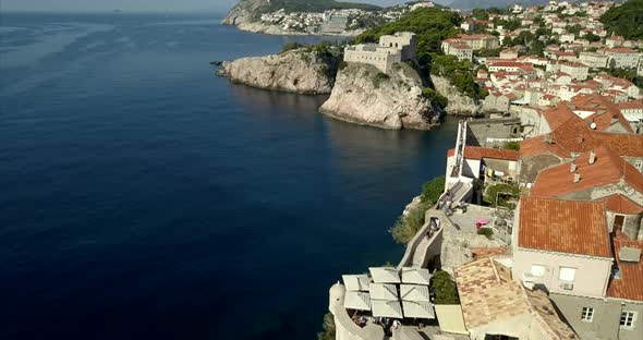 Dubrovnik Old Town city walls and coast line. the camera passes by the walls and close by Fort Lovri