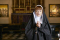 nun in church praying with rosary - PhotoDune Item for Sale