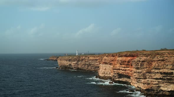 Maritime Scenery with Rocky Cape and Lighthouse