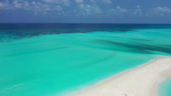 Beautiful overhead travel shot of a white sand paradise beach and aqua blue water background in best