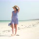 Young Woman Walks Barefoot On Beach Along Ocean - VideoHive Item for Sale