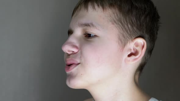 Closeup of a Face Profile of Talking Smiling Teenager Looking Down