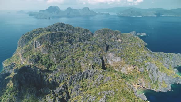 Mount Island at Blue Seascape of Ocean Bay in Aerial View