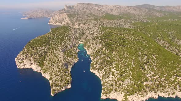 Aerial travel drone view of clear green water, cliffs of Cassis, Mediterranean Sea, Southern France.