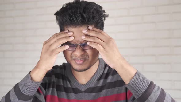 Young Man Suffering Headache Close Up