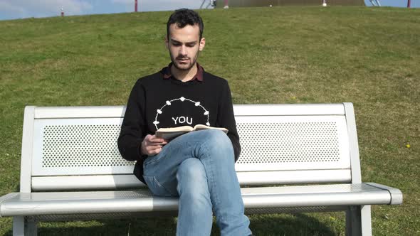 Reading Novel At White Bench