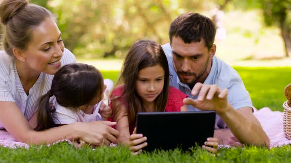 Family with Tablet Pc on Picnic in Summer Park