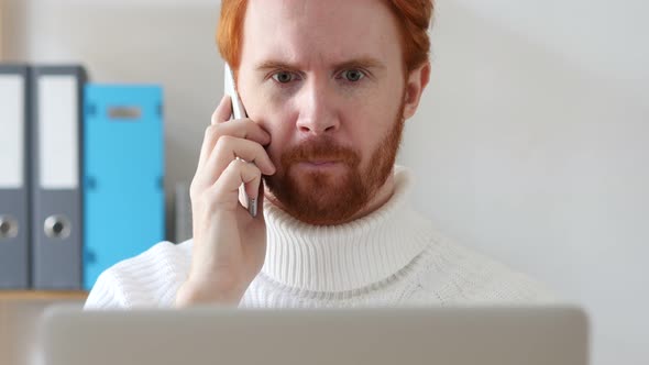 Man with Red Hairs Talking on Phone, Discussing