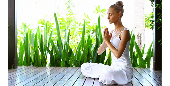Woman Practicing Yoga And Meditating