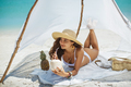 Woman Drinking Coconut Juice while Relaxing on the Beach - PhotoDune Item for Sale
