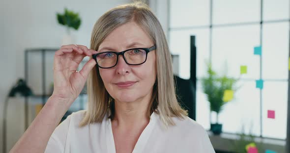 Businessswoman which Taking off Her Glasses When Looking Into Camera with Happy Face Expression