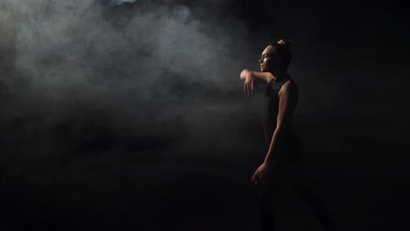 Tender Girl Dancing in Darkness of Smoky Studio