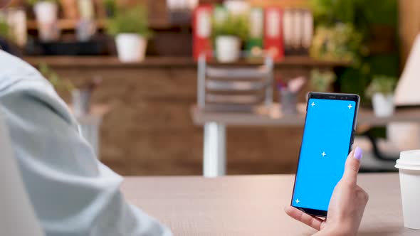 Woman Hands Holding a Smartphone with an Isolated Mock-up Screen