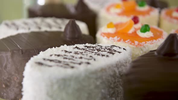 Delicious and Beautiful Cakes Lie on a Spinning Glass Shop Window