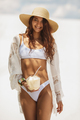 Tanned Woman in Bikini with Coconut on the Beach - PhotoDune Item for Sale