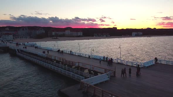 Cinematic pier in the sunset from a bird's eye view. Filming at sunset in Sopot.