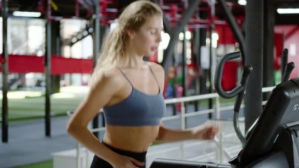 Fit Woman Exercising on Treadmill, Doing Fitness Exercise. Muscular Athletes Training in the Gym