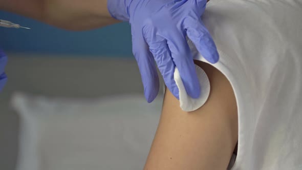 Hands of a Nurse Giving a Vaccine to a Patient