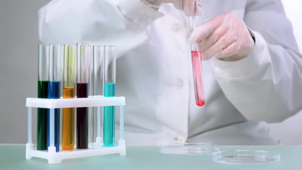 Scientist Making a Chemical Experiment in Research Center