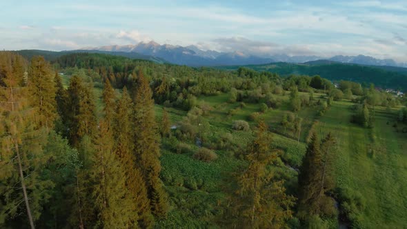 Aerial View of a Mountain Landscape with Rocky Peaks on the Background