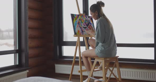 Hobby at Home During Selfisolation Woman Artist is Painting Picture on Canvas Near Window in Wooden