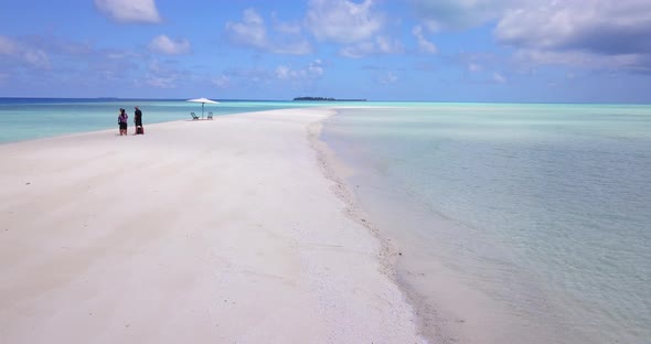 Wide angle birds eye abstract shot of a white sand paradise beach and blue water background in best 
