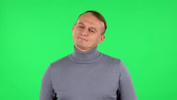 Portrait of Male Daydreaming and Smiling Looking Up. Green Screen