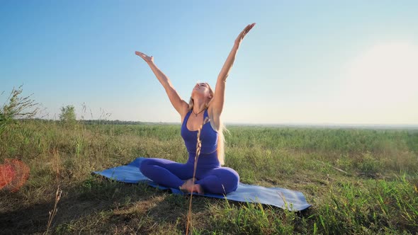 Woman Is Doing Yoga. Dawn, Green Field.